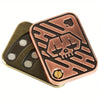 A copper-toned metal fidget slider toy featuring an engraved skull design and a sliding mechanism.