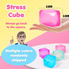 A hand holds a pink stress cube, demonstrating the squishy fidget toy. Multiple colored cubes are also visible.