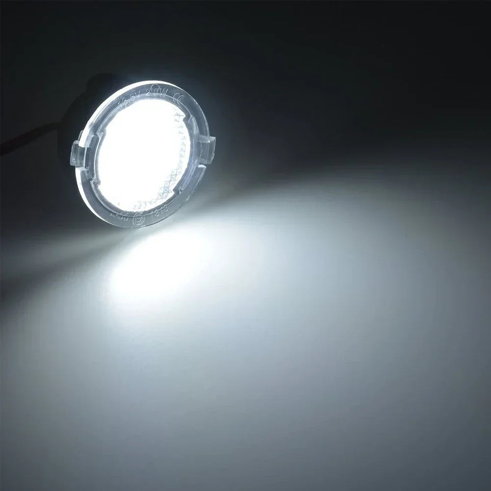 A bright LED puddle light mounted on a side mirror, illuminating the ground below.