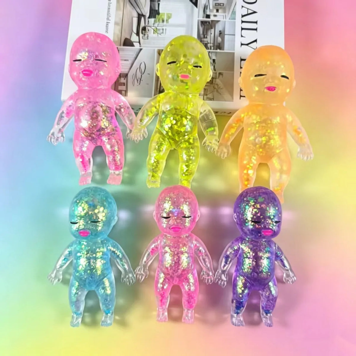 A collection of squishy stress relief toys in various colors including pink, yellow, orange, blue, and purple.
