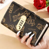 A brown leather wallet featuring a cartoon bear design and a gold lock, held by a hand.