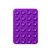 A purple silicone suction pad with multiple circular indentations for phone mounts.