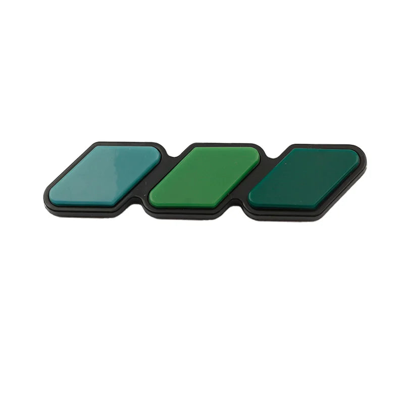 A set of three green and teal colored grille emblem stickers for Toyota trucks and SUVs.
