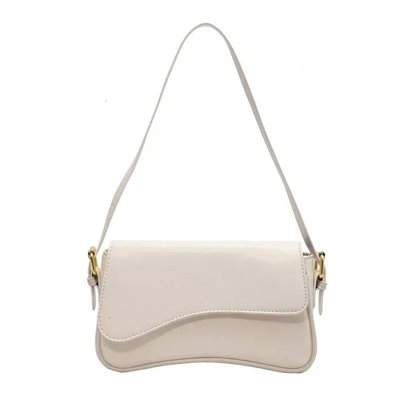 A light beige vintage leather crossbody bag with a flap closure and thin strap.