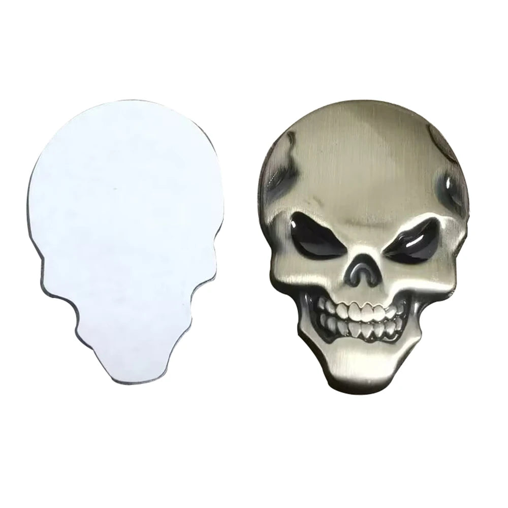 A metallic chrome skull emblem badge for car and motorcycle, shown in profile view.