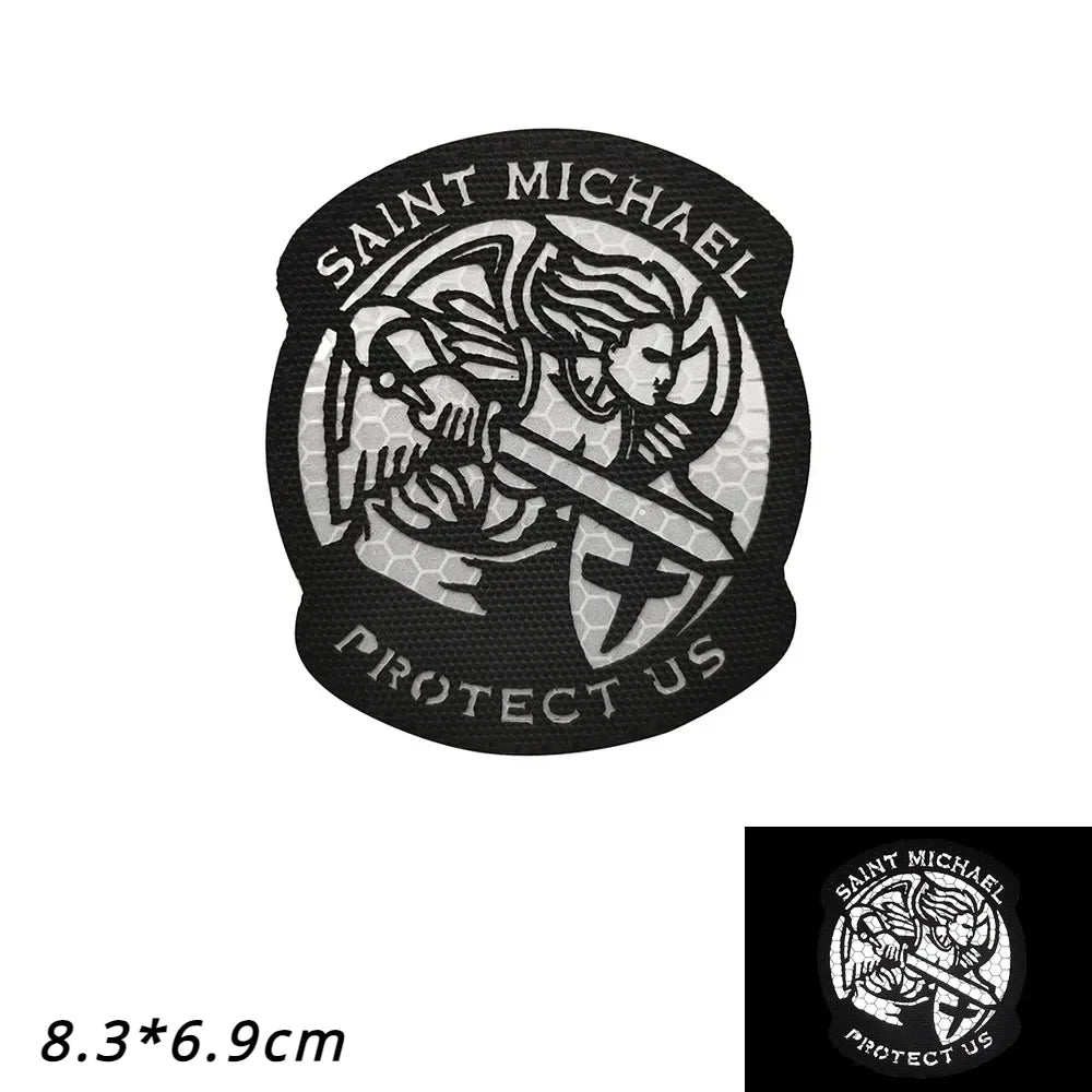 Black reflective patch featuring the text SAINT MICHAEL PROTECT US and an archangel design.