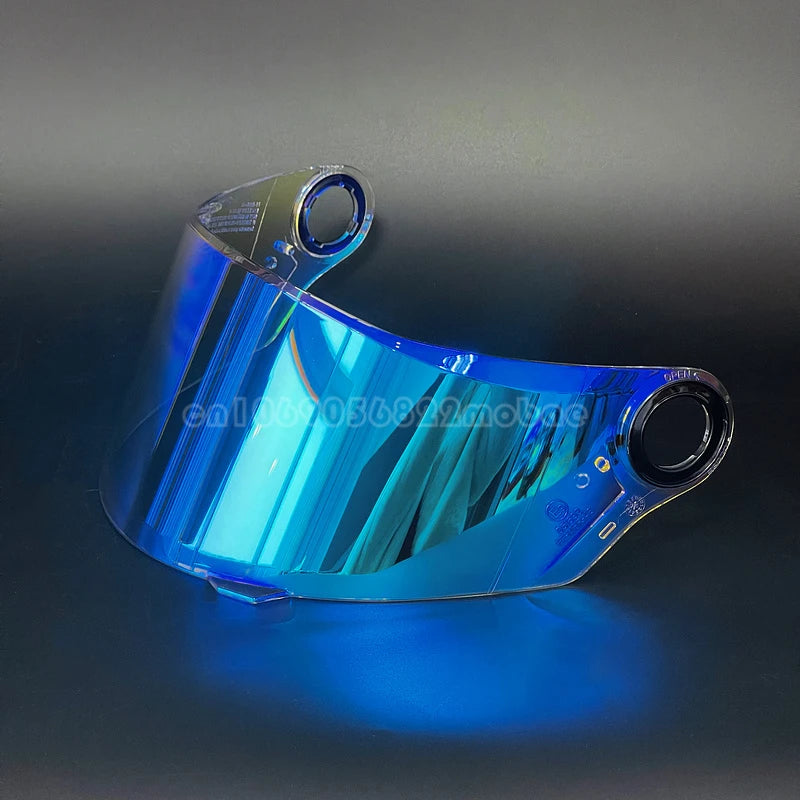 A clear blue replacement motorcycle helmet visor displayed on a dark surface.