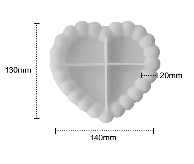 A heart-shaped silicone tray mold with a decorative ruffled edge and a cross design, shown with dimension lines.
