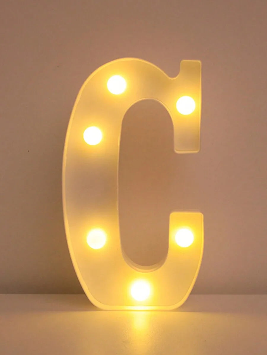 A glowing letter C made of LED lights used as a night light or party decor.