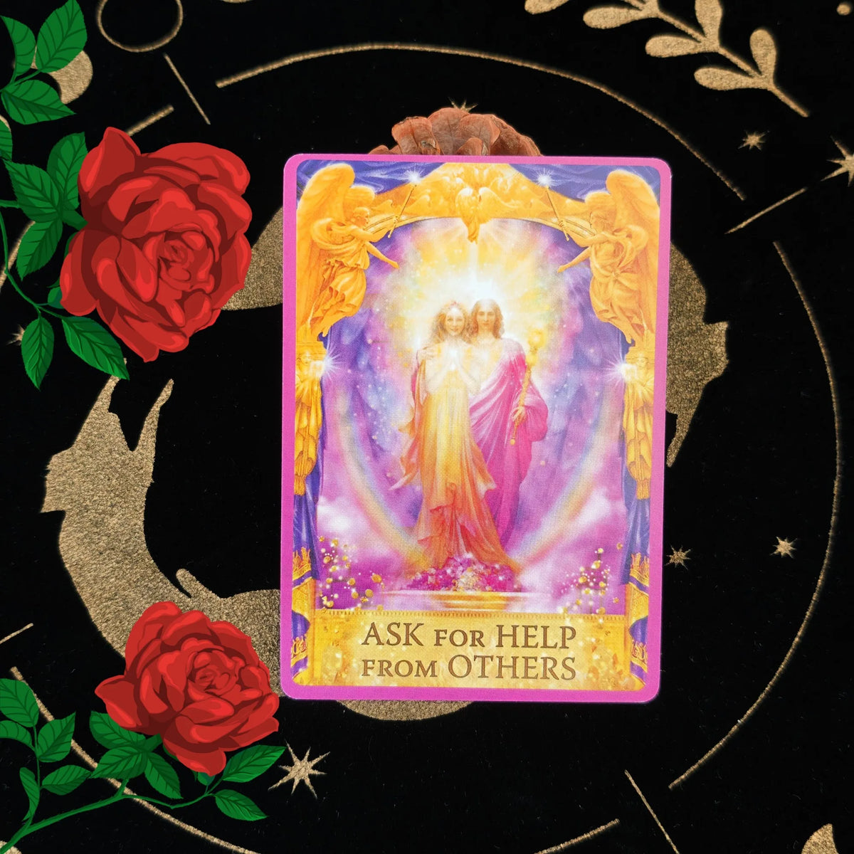 A tarot card featuring two figures in a radiant light framed by golden wings, asking for help from others.