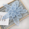 Light blue sequin floral lace applique patch for sewing and DIY crafts displayed on a wooden board.