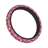 A black steering wheel cover with a pink and camouflage pattern.