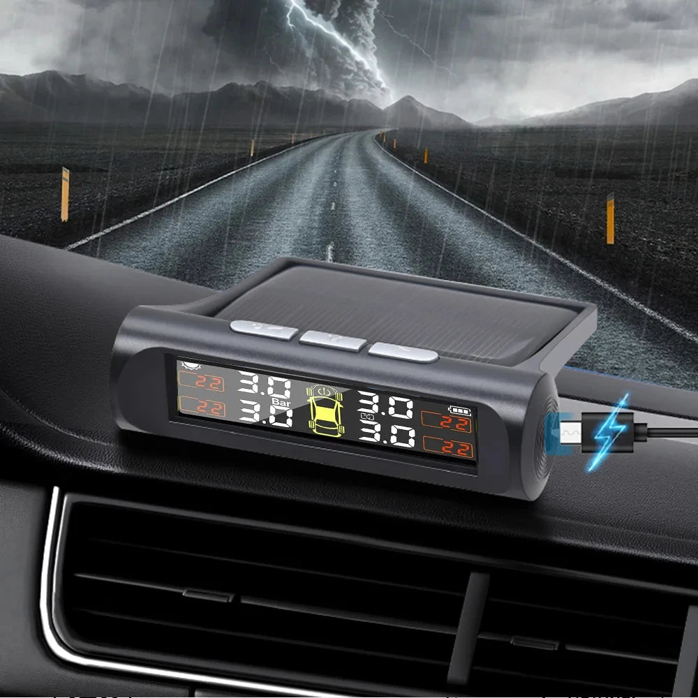 A black tire pressure monitoring device is mounted on a car's dashboard, set against a dramatic stormy landscape.