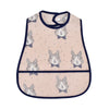 A light pink baby feeding bib featuring a repeating pattern of gray rabbits and a black trim.