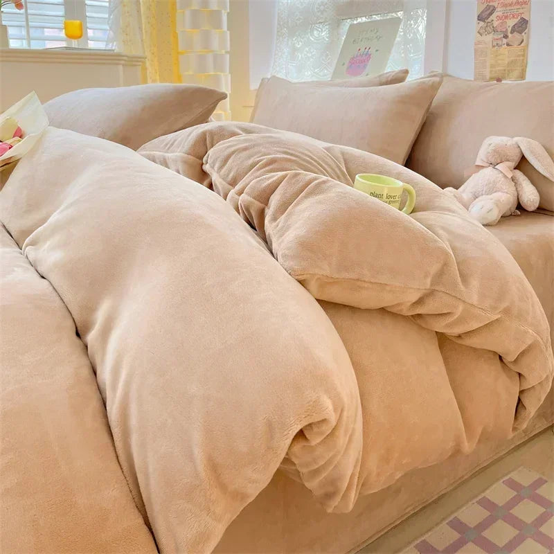 A beige cozy milk velvet bedding set featuring a duvet cover and pillows on a bed.
