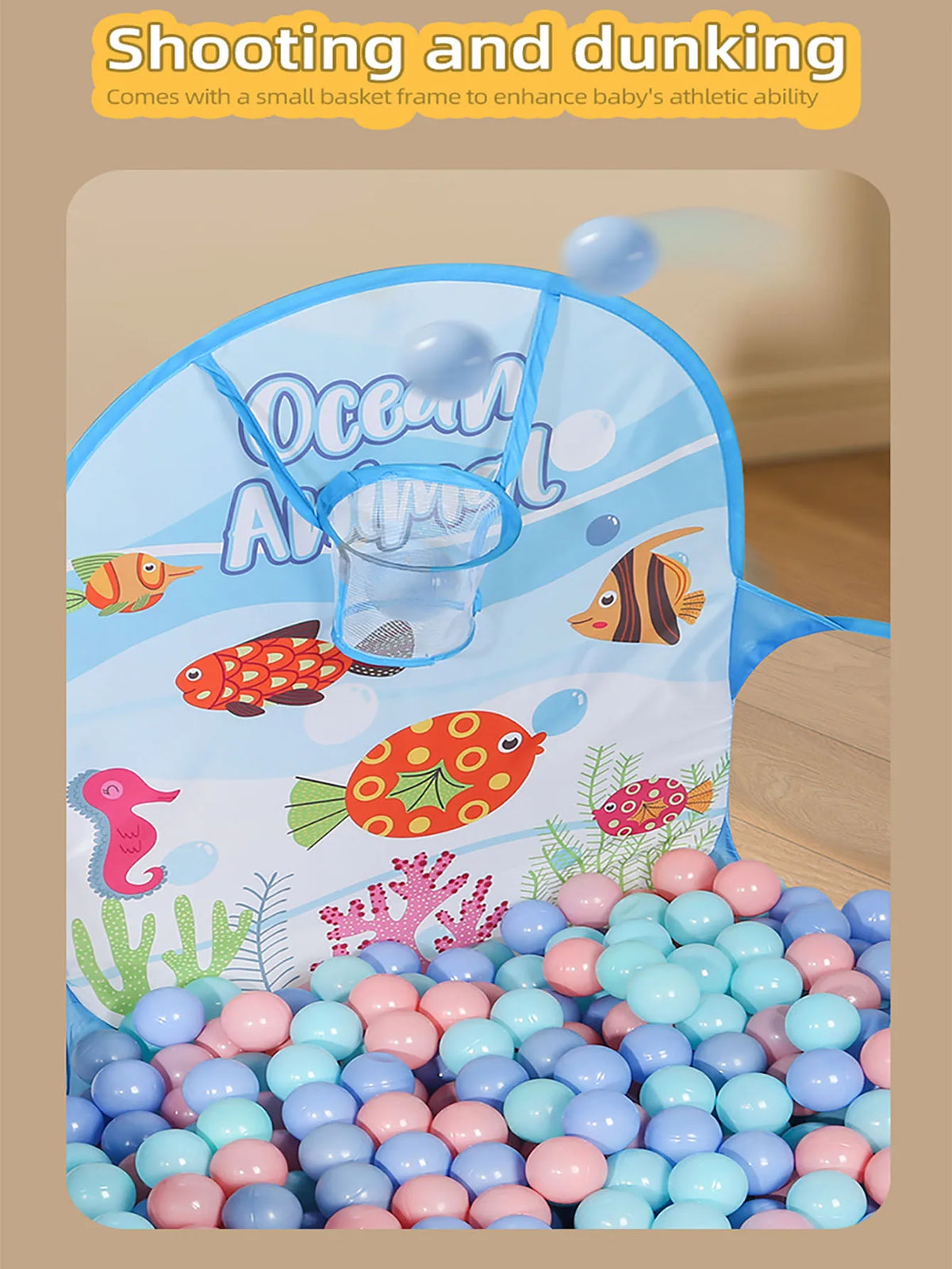 A blue playpen with a basketball hoop and various colored balls for baby's athletic activity.