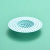 A white silicone sink drain filter strainer with a perforated design is shown against a light green background.