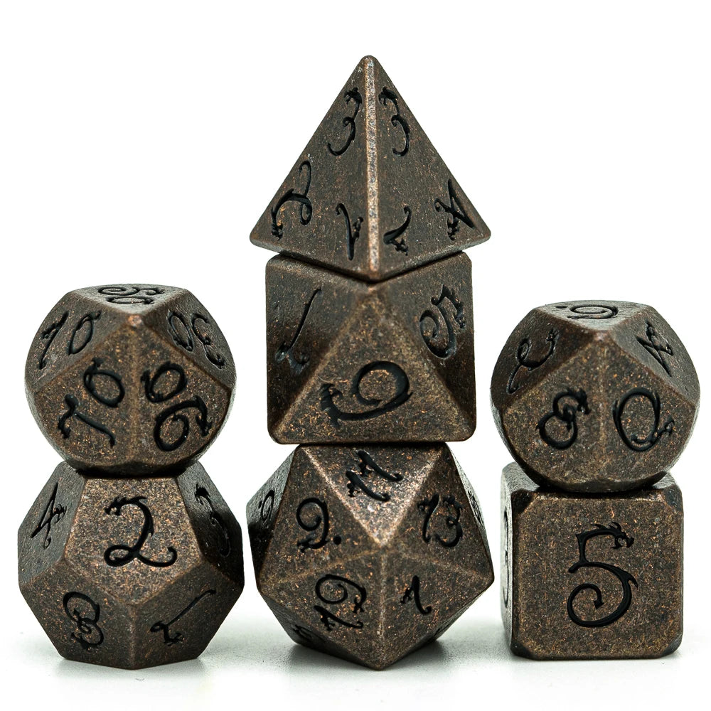 A set of seven metal polyhedral dice with a dragon font design arranged in a pyramid shape.