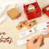 A set of red and brown stationery including envelopes and note cards for love notes is displayed on a light fabric surface.