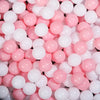 A close-up view of a large pack of pink and white colorful ball pit balls for toddlers.