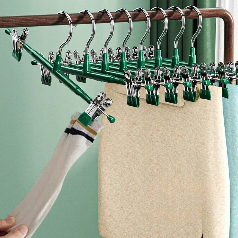 A set of five anti-slip stainless steel hangers with clips hanging on a wooden rack.