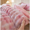 A close-up of a pink faux fur comforter draped on a bed, showing its soft texture and pink and white mottled pattern.