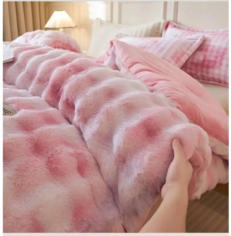 A close-up of a pink faux fur comforter draped on a bed, showing its soft texture and pink and white mottled pattern.