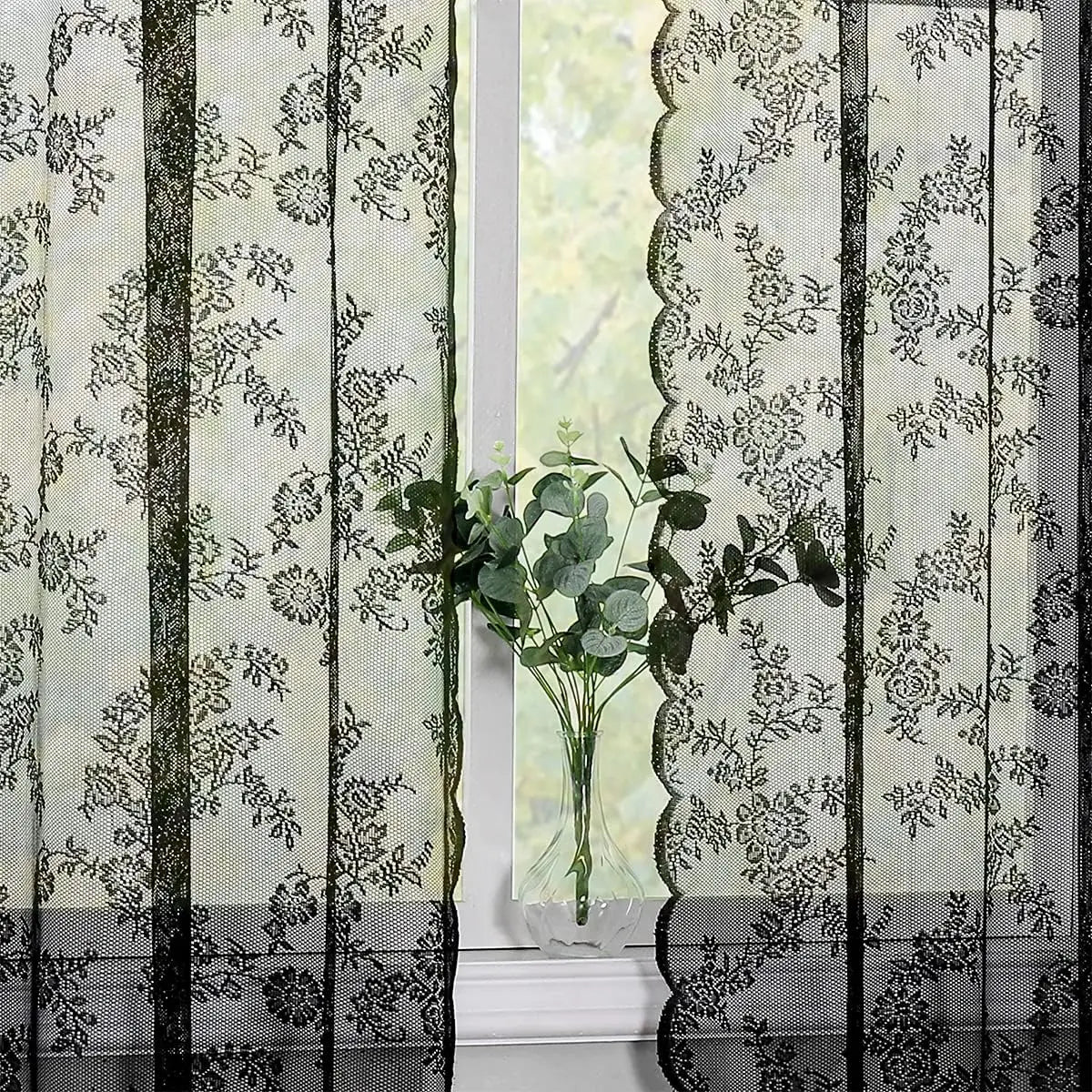 Vintage floral lace curtain panel with light filtering featuring a delicate pattern and vertical stripes.