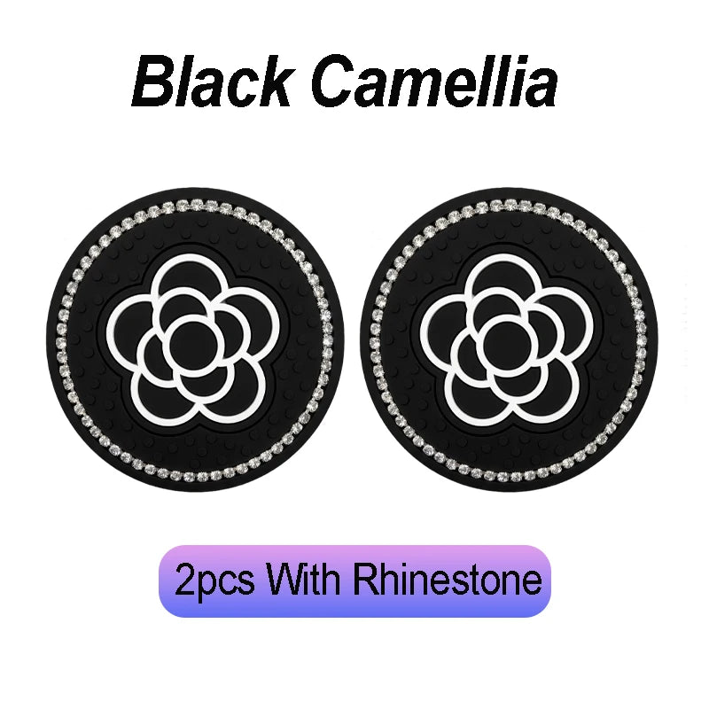 Two black camellia pattern coasters with rhinestone borders