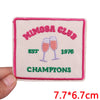 Pink embroidered patch for a Mimosa Club championship, featuring champagne glasses and the year 1976.
