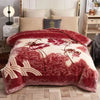 A deep red and cream weighted plush blanket with a floral pattern displayed on a bed.