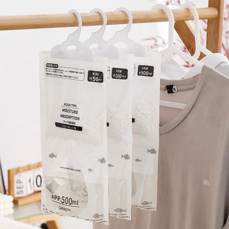 A clear hanging bag labeled Moisture Absorption with a hook type for closet and wardrobe storage.