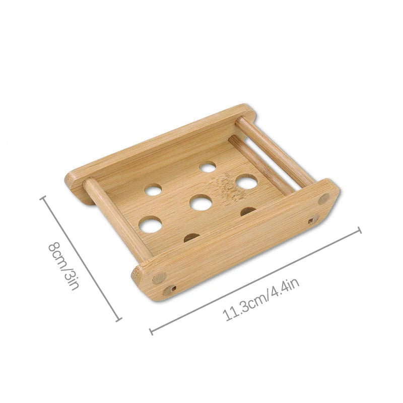 A light brown natural bamboo soap dish with multiple holes for fast-drying drainage.