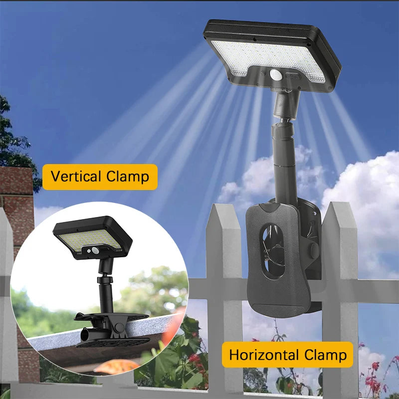 A vertical and horizontal clamp solar-powered motion sensor outdoor light mounted on a wooden fence.