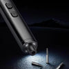 A close-up view of a metallic precision screwdriver set with a magnetic case and rechargeable battery on a dark surface.
