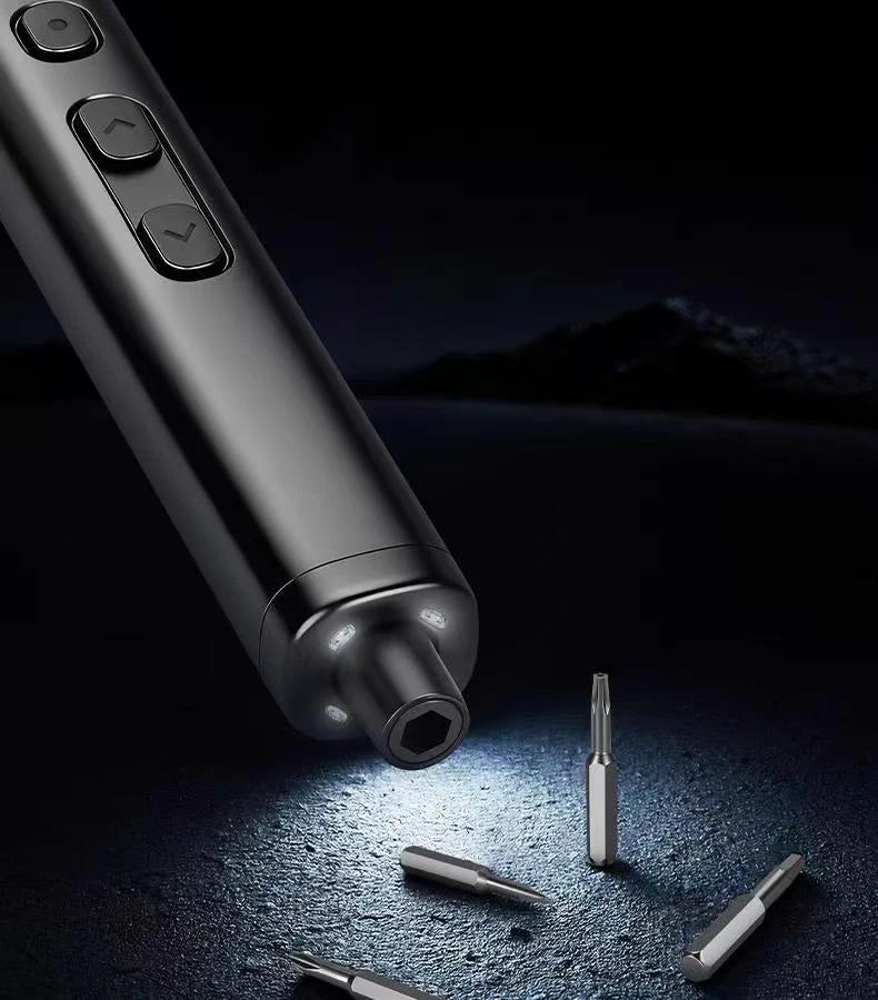 A close-up view of a metallic precision screwdriver set with a magnetic case and rechargeable battery on a dark surface.