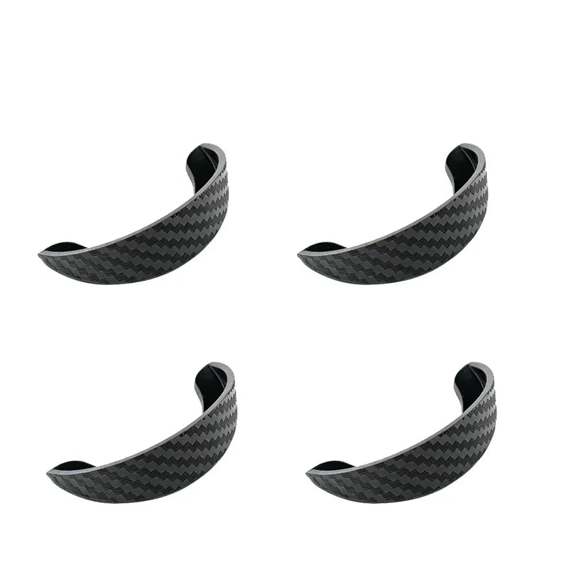 A close-up view of a black carbon fiber rain cover visor for a car rear camera.