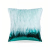 A decorative pillow featuring a fluffy light blue fur layer over a sparkling teal sequin base.