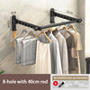 Black 8-hole wall-mounted clothes drying rack with a 40cm rod displaying hanging garments