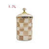 A square porcelain storage jar with a gold lid featuring a beige and white checkerboard pattern.