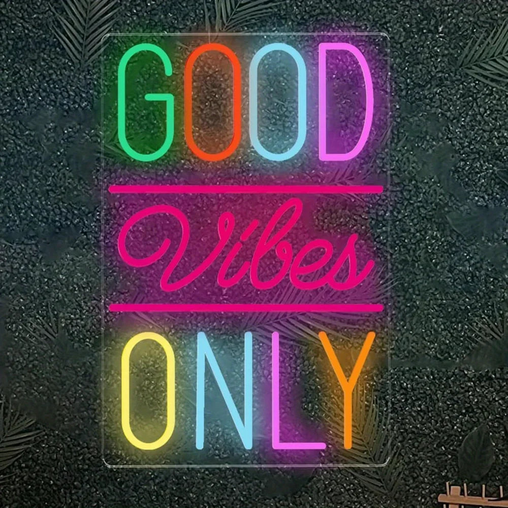 An LED neon sign displaying the text GOOD VIBES ONLY in bright, colorful neon lights against a dark background.