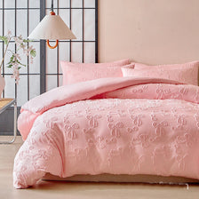 Pink duvet cover set with a Nordic leaf print pattern displayed on a bed.