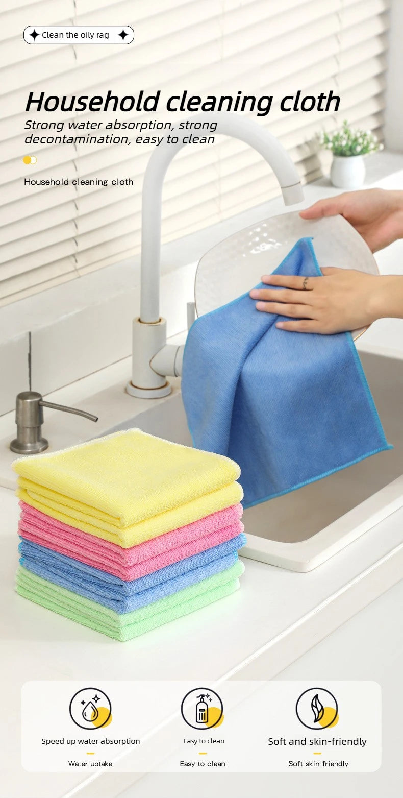 A hand is cleaning a surface with a blue cloth, surrounded by stacks of colorful reusable microfiber cleaning cloths.