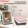 Folding design vanity mirror with customizable LED lights shown in a dorm room setting