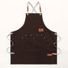 A dark brown canvas kitchen apron with straps and large pockets.