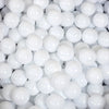 A close-up view of a large quantity of white, spherical ball pit balls.