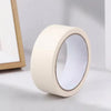A roll of white masking tape with a clear plastic window, shown next to a wooden frame.