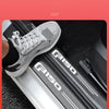 A close-up of a gray PU leather door sill protector sticker installed on the interior trim of a Ford F-150.