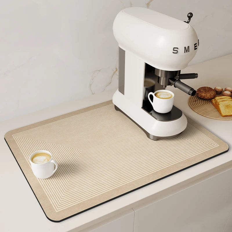 A white espresso machine is placed on a beige woven counter mat on a light surface.