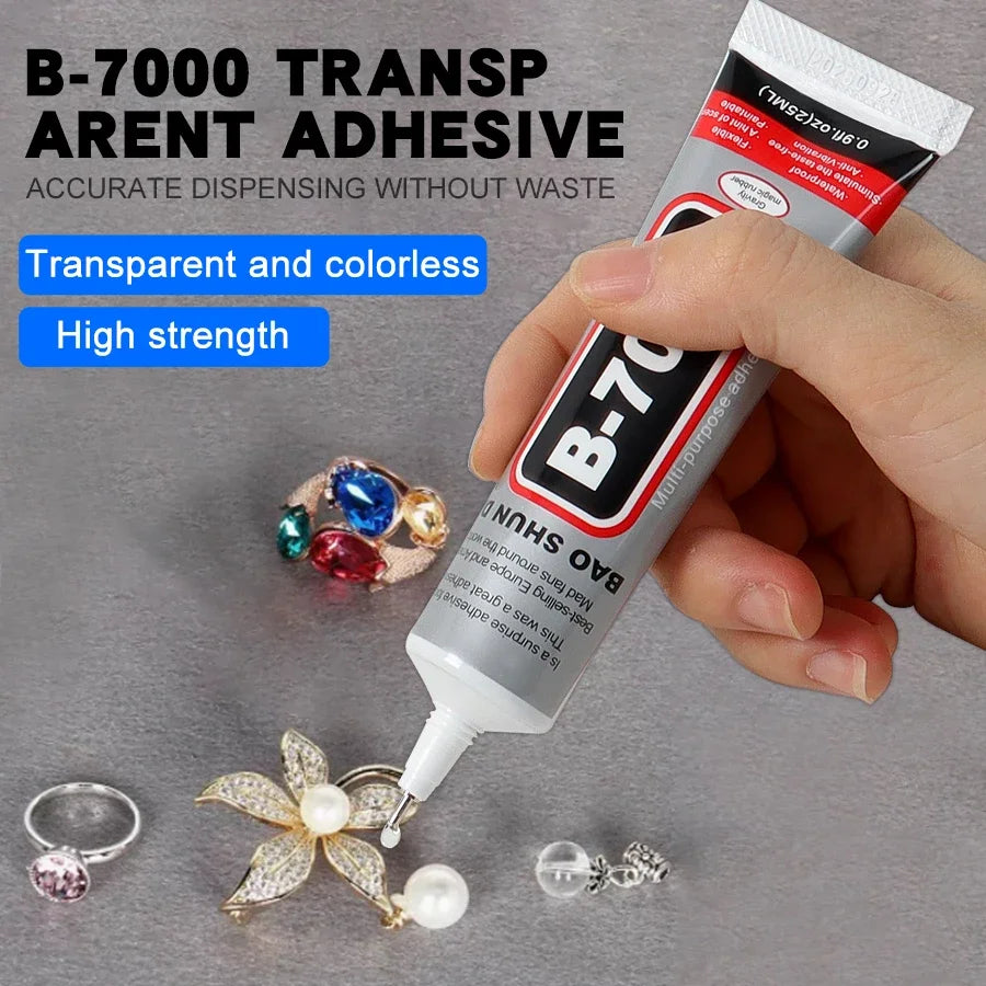 A hand is applying B-700 transparent and colorless adhesive to jewelry pieces like rings and flowers.